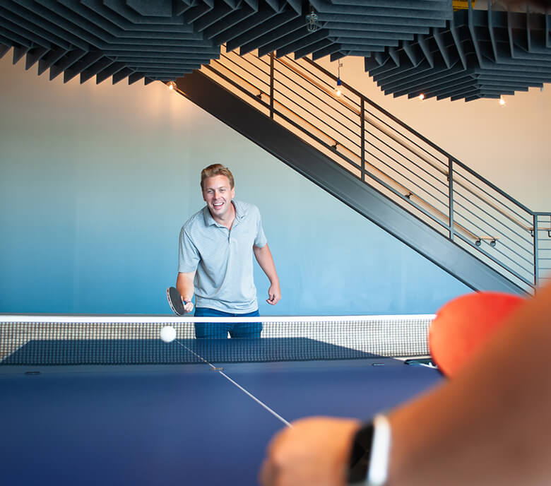 A Monte Rosa team member plays ping pong in the Boston location.