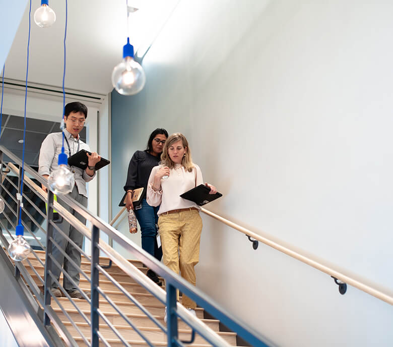 Monte Rosa staff walk down the stairs in the Boston location.