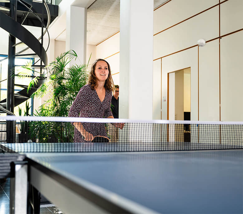 A Monte Rosa team member plays ping pong in the Basel location.