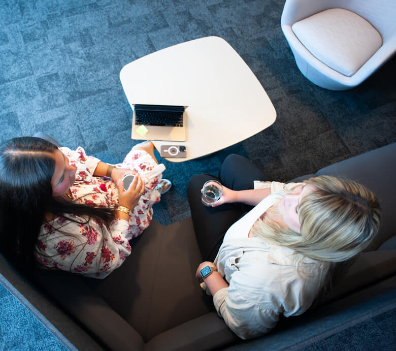 Two Monte Rosa team members engage in conversation in the Boston location.