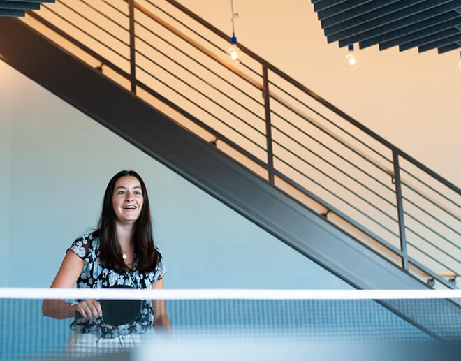 A Monte Rosa team member plays ping pong during a break at the office.